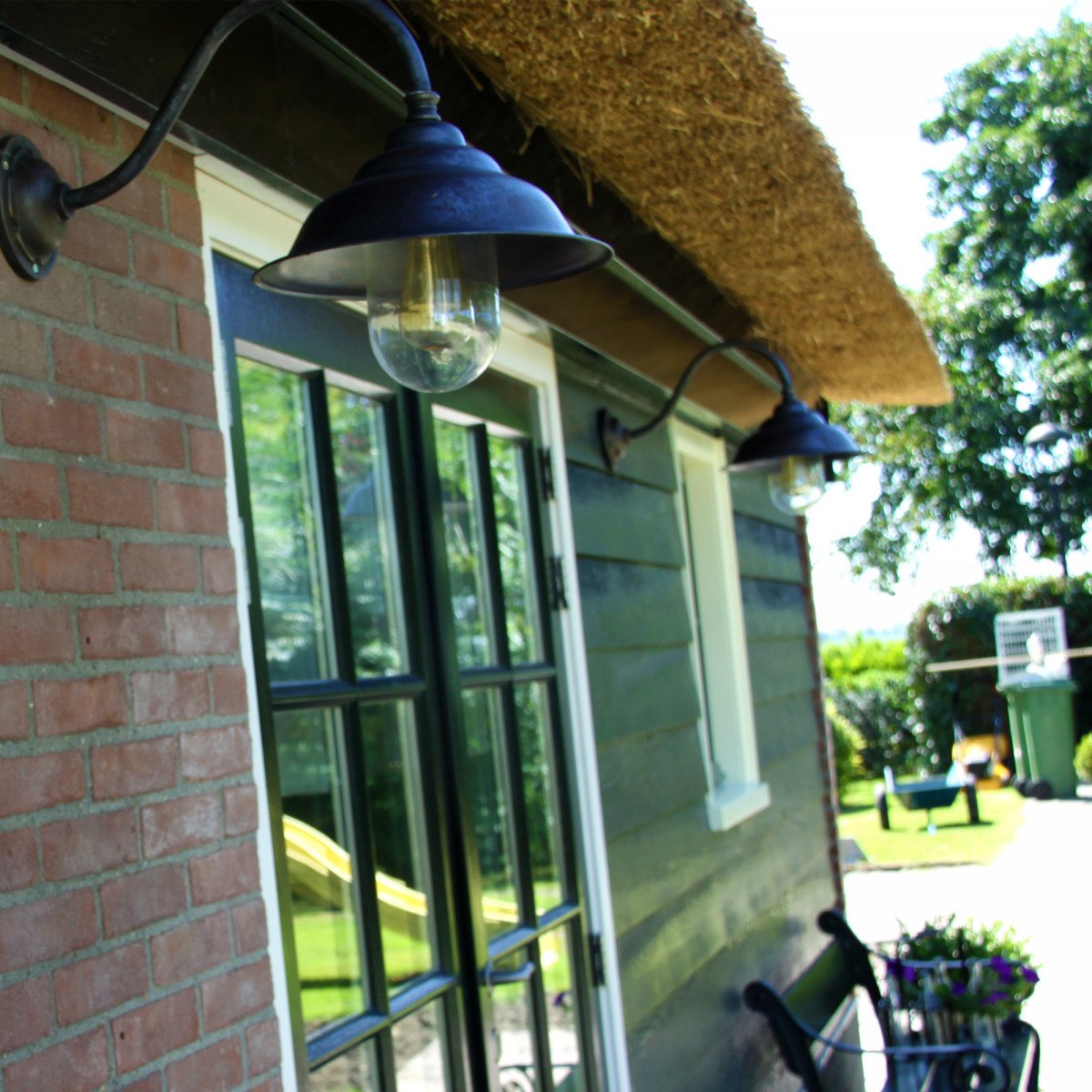 Klassieke stallamp brons koper met gebogen wandarm en heldere beglazing, prachtige buitenlamp van KS Verlichting.